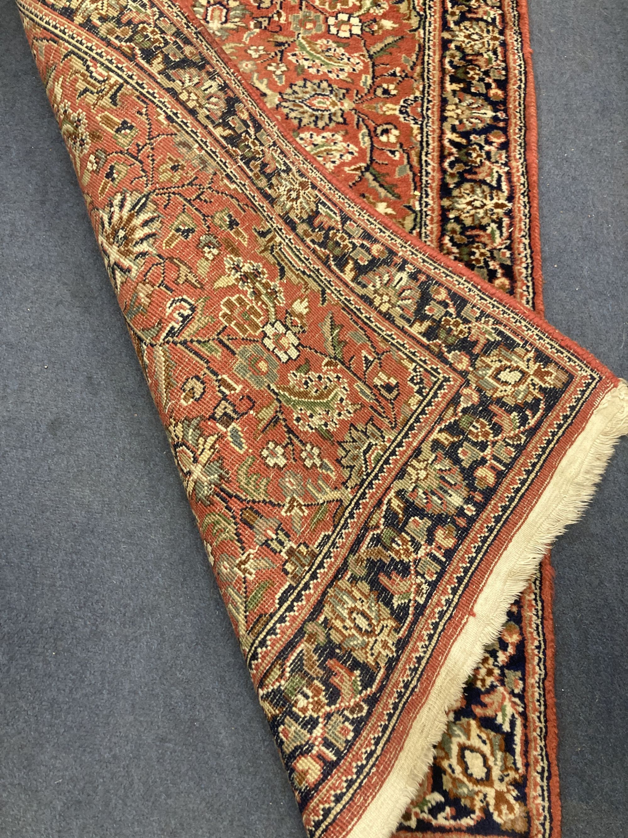 A Persian burgundy red ground rug, 146 x 69cm